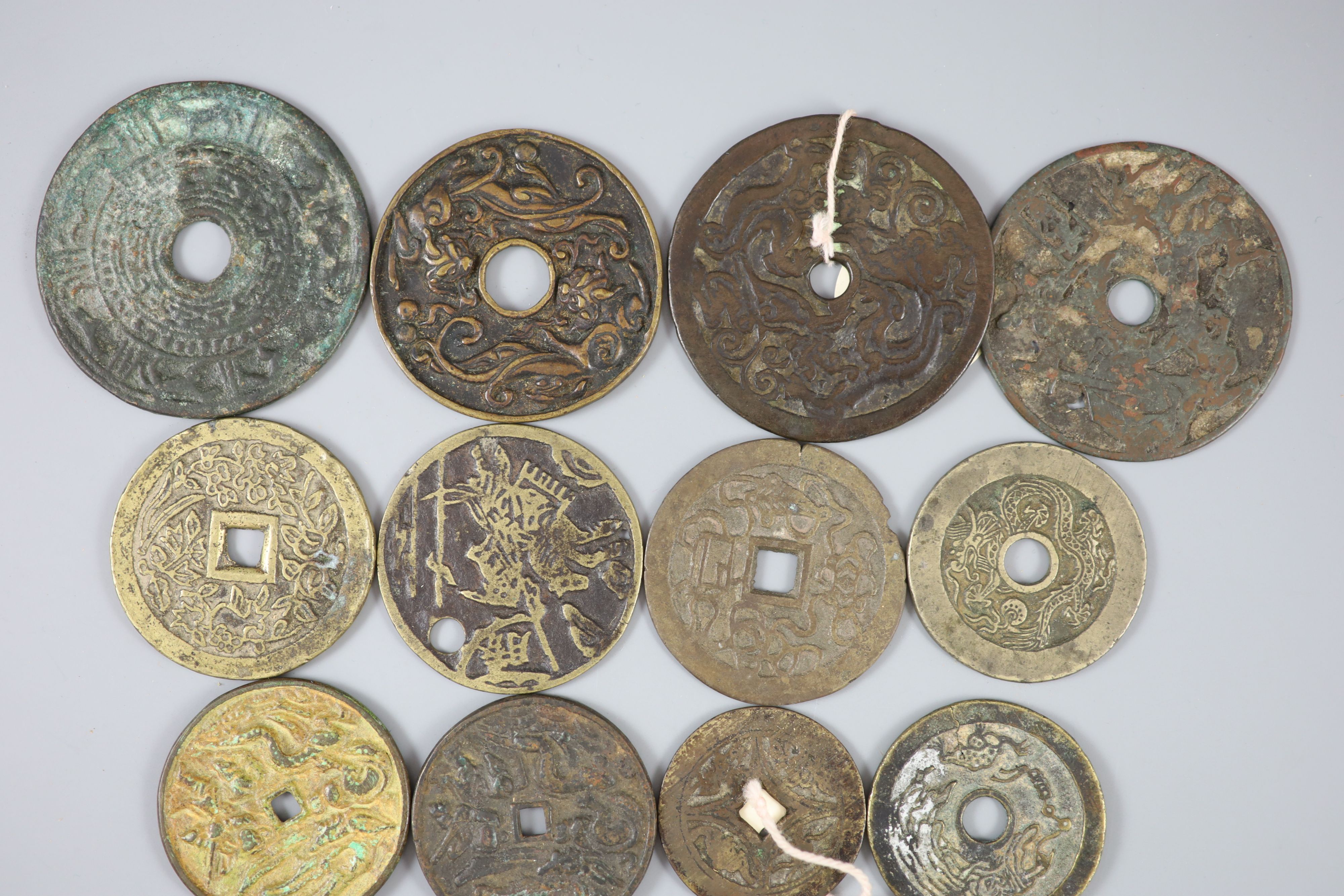 China, 17 bronze or copper charms or amulets, Qing dynasty or earlier,
